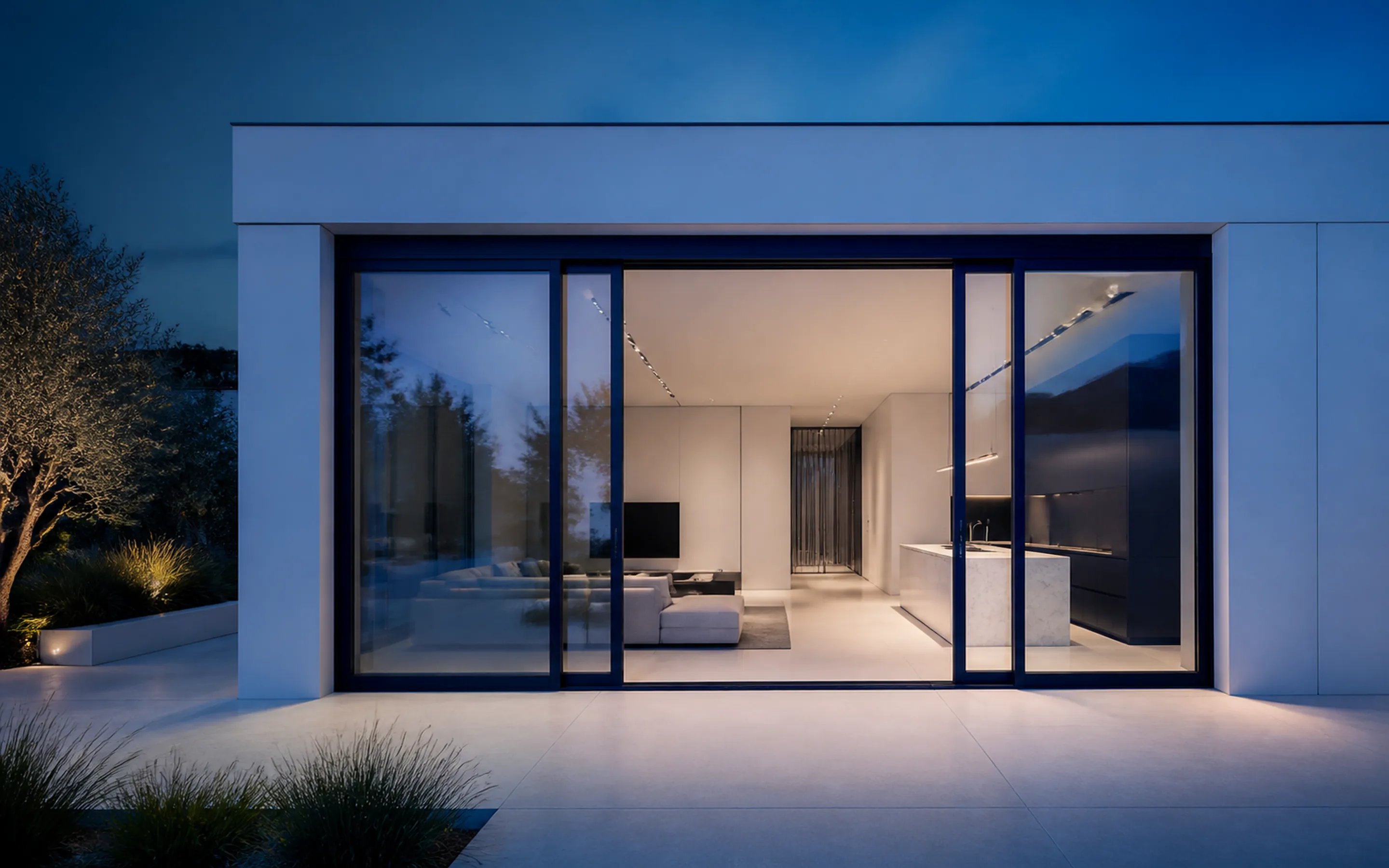 Modern residence at dusk with a full-height aluminium sliding system
